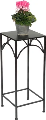 A black metal plant stand with a potted pink cyclamen plant on top.