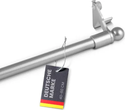 A close-up of a silver curtain rod with a tag attached.