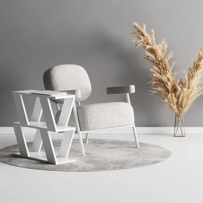 A modern living room scene with a side table, armchair, and dried flowers.