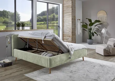 Produktbild von Meise Möbel Stauraumbett Mattis 180x200 cm | Doppelbett | Bettkasten & Lattenrost (Federholzrahmen) | Strukturstoff Hellgrün | Holzfuß eichefarbig