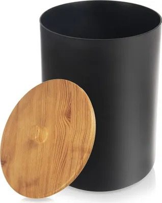 A black cylindrical trash can with a wooden lid placed next to it.