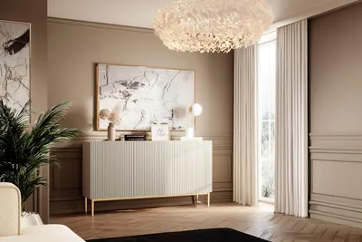 A modern living room with a white sideboard, artwork, and a large chandelier.