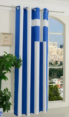 A close-up of a curtain with the Greek flag pattern hanging in front of a window with a view of ancient ruins.