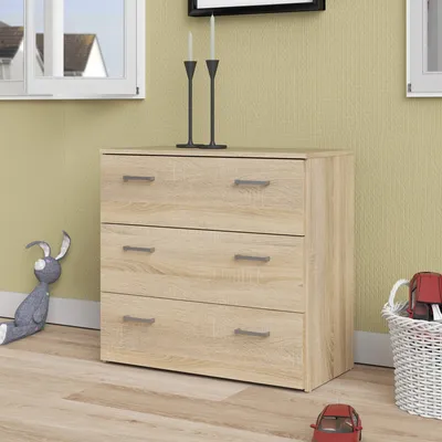 A chest of drawers in a room with a window and a stuffed rabbit.