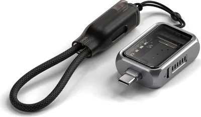 A close-up shot of a Satechi mini NVME SSD enclosure with a USB-C connector and a braided lanyard.