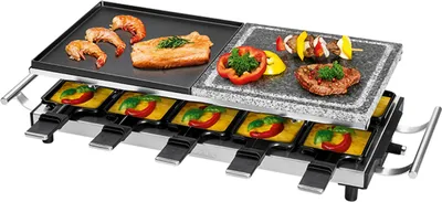 A raclette grill with food on it, set against a white background.