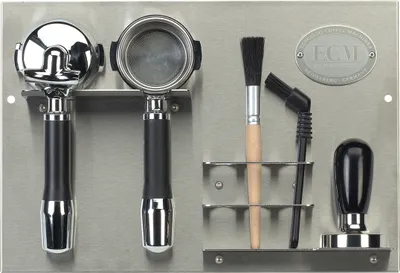 A wall-mounted organizer for espresso machine accessories.