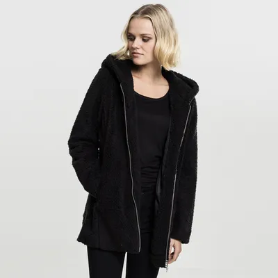 A woman wearing a black hooded jacket.
