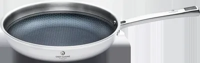 A stainless steel frying pan with a honeycomb pattern on the interior.