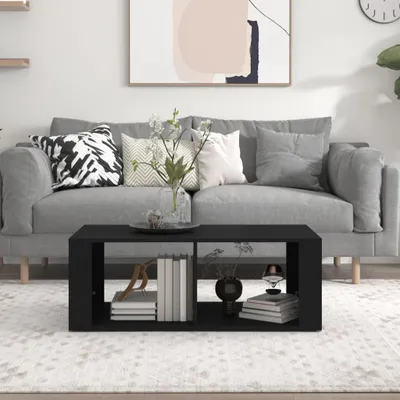 A living room scene with a sofa, coffee table, and artwork.