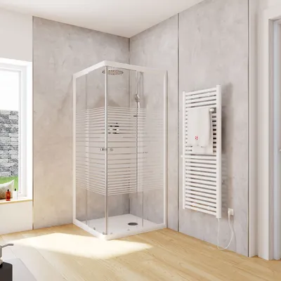 A modern bathroom with a glass shower enclosure, a towel warmer, and a window.