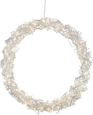 A silver wire wreath with embedded warm white LED lights, suspended by a thin white cord against a white background.