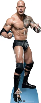 A cardboard cutout of Dwayne 'The Rock' Johnson in wrestling attire, standing on a light blue base. A smaller cutout of a wrestler is at the base.