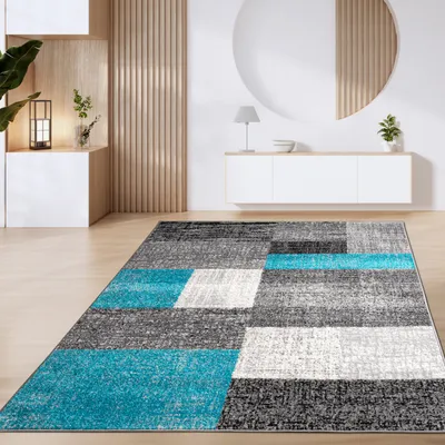 A modern living room with a geometric rug.
