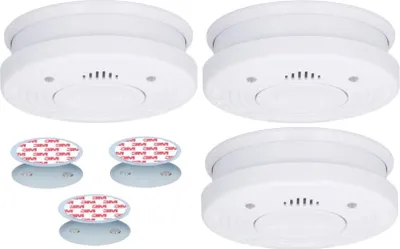 Four white smoke detectors and four adhesive mounting pads are arranged on a white background.
