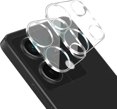 A close-up shot of a phone's camera lens protector being placed on a black smartphone.