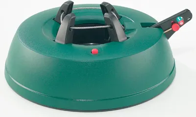 A green Christmas tree stand with a red indicator light and a black lever mechanism.