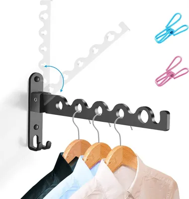 A black foldable wall-mounted drying rack with several hangers holding shirts, and clips in the background.