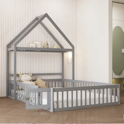 A children's house bed with safety rails and a mattress in a room.