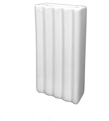 A white ceramic vase with vertical ridges.