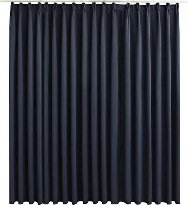 A full-frame shot of a dark grey curtain hanging from a rod.