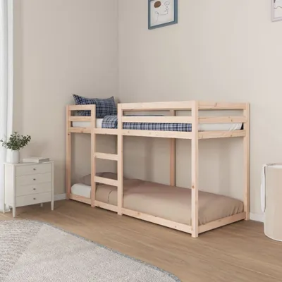 A wooden bunk bed in a room with a nightstand and a rug.
