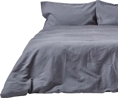 A close-up view of a gray linen duvet cover and pillowcase set on a bed.