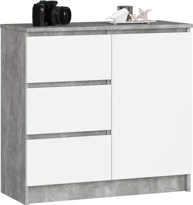 A white and gray dresser with three drawers on the left and a door on the right, placed on a white background. Decorative items are on top of the dresser.
