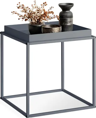 A modern gray side table with decorative items on top.