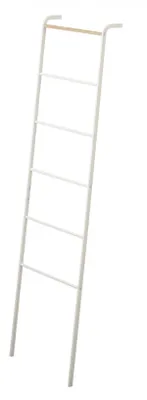 A white ladder-like rack with a light brown wooden bar at the top, shown against a white background.