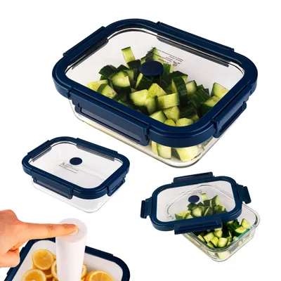 Multiple glass food storage containers with blue lids, some filled with chopped cucumbers and one with lemon slices, with a hand pressing a button on a vacuum pump.