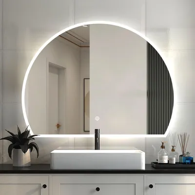 A bathroom vanity with a sink and a large illuminated mirror.