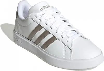 A white Adidas sneaker with gray stripes.