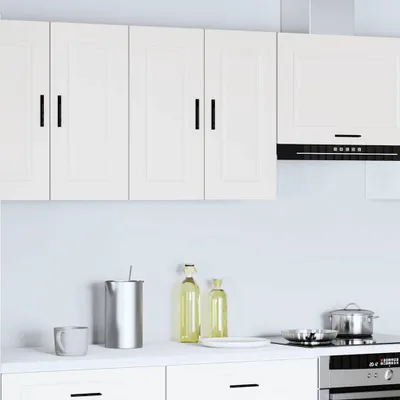 A clean, modern kitchen scene with white cabinets and appliances.