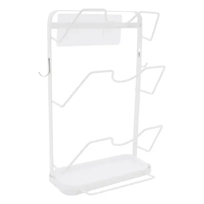 A white metal pot lid organizer with a tray at the bottom.