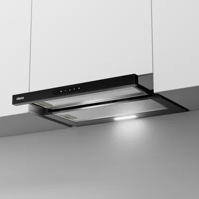 A black range hood installed under white kitchen cabinets.