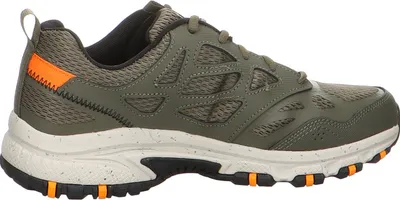 Side view of a single green and orange athletic shoe.