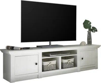 A white TV lowboard with a television on top.