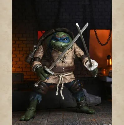 A Teenage Mutant Ninja Turtle action figure, Leonardo, dressed as The Hunchback, holding two swords.