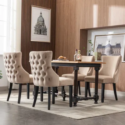A dining set with four chairs around a table in a room with wood-paneled walls.