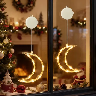 Christmas-themed window decoration with moon-shaped lights.