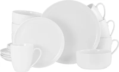 A collection of white ceramic dishes, including plates, bowls, and mugs, neatly arranged.