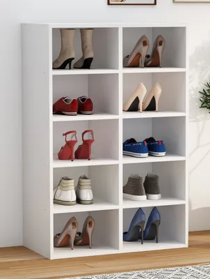 A white shoe rack filled with various pairs of shoes.