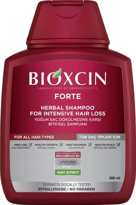 A maroon bottle of Bioxcin Forte Herbal Shampoo for Intensive Hair Loss against a white background.