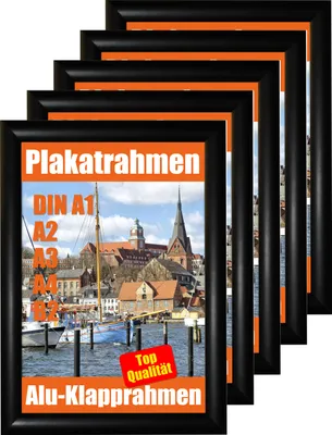A stack of black poster frames with orange borders, displaying a scenic town with a church and a sailboat.