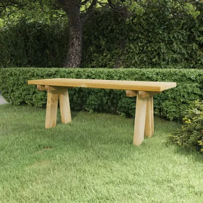 A wooden bench sits on a grassy lawn in front of a dense green hedge and a tree.