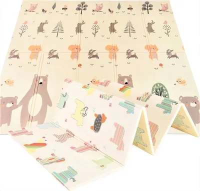 A folded baby play mat with cartoon animal and vehicle prints.