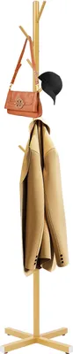 A gold coat rack with a handbag and a hat on it.