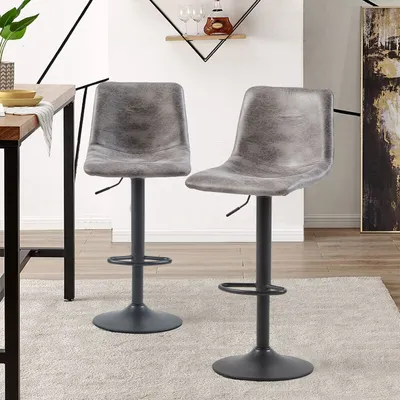Two gray bar stools are shown in a modern dining or kitchen area, next to a wooden table.