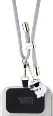 A close-up of a phone lanyard with a charm.